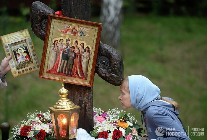 Женщина у поклонного креста на Ганиной Яме. © РИА Новости / Павел Лисицын